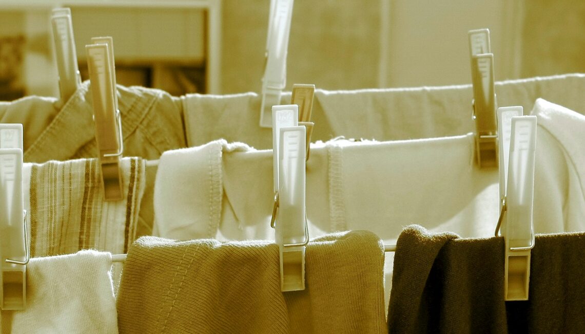 white plastic clothes hanger on brown textile